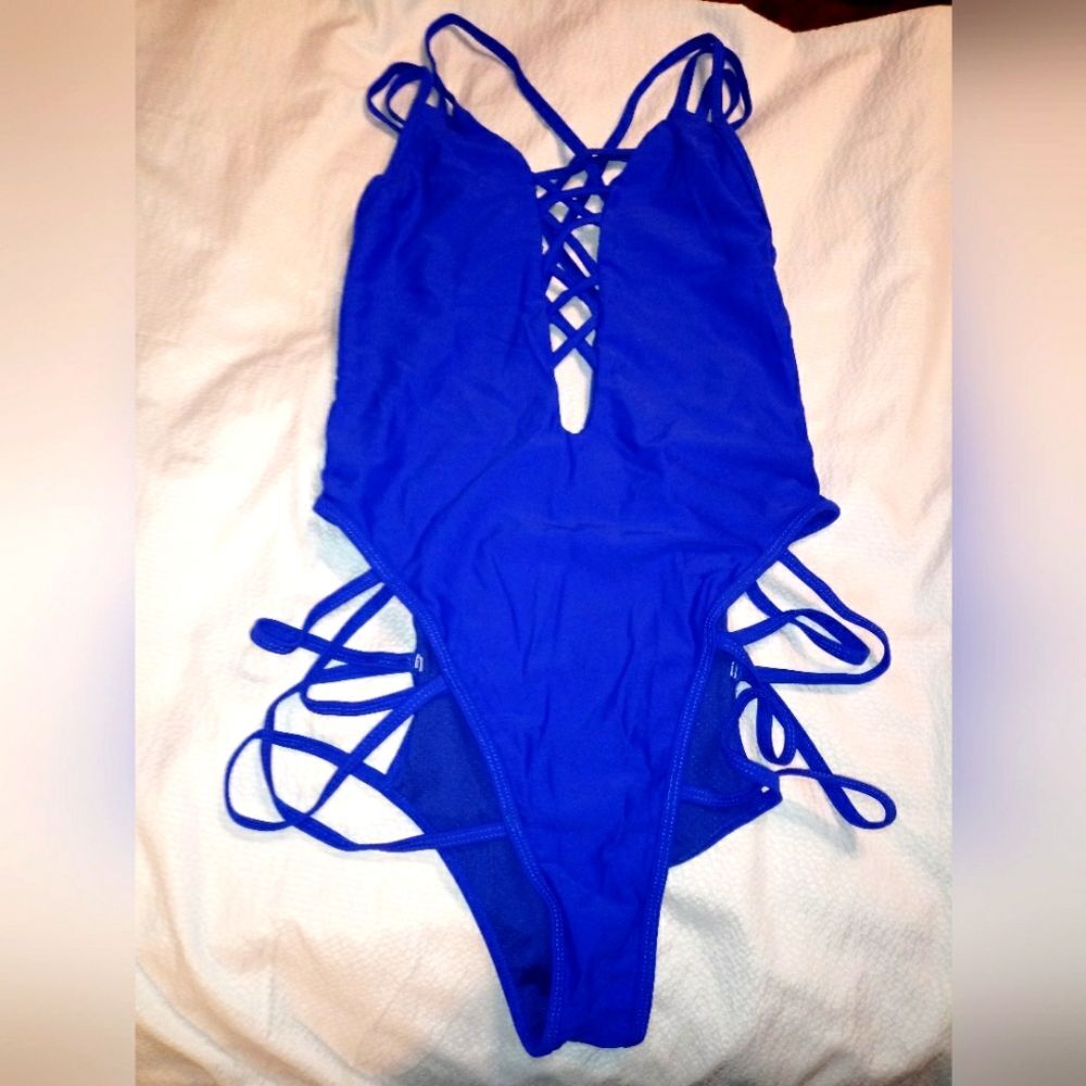 NWOT STRAPPY ONE PIECE.  HIGH LEG V LOW CUT V FRONT STRAPPY BACK
